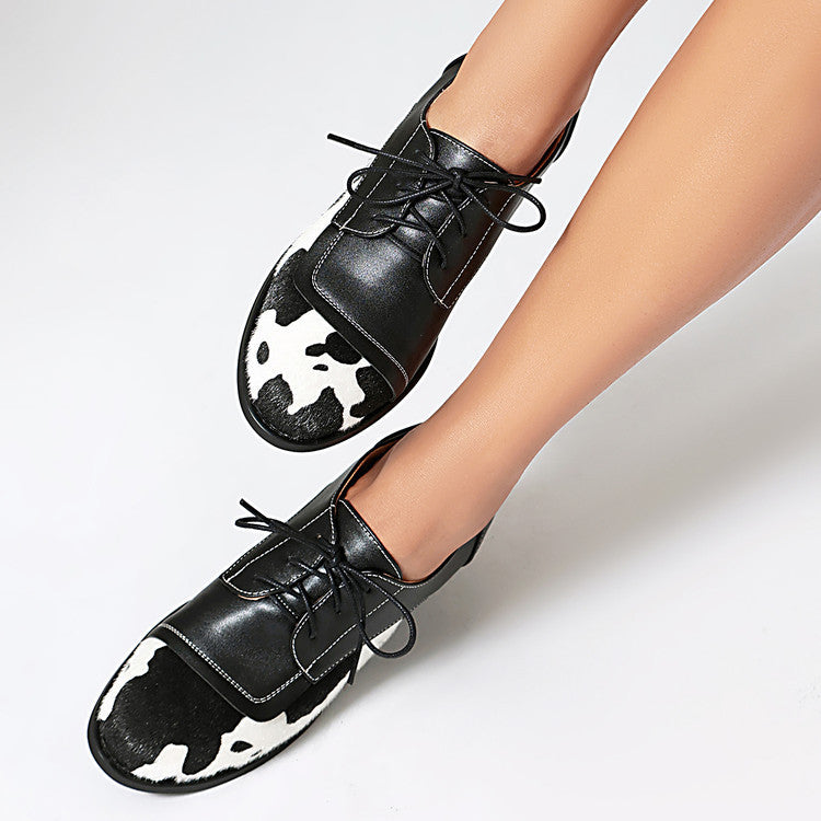 Round toe low-cut suede-trimmed cow-print loafers