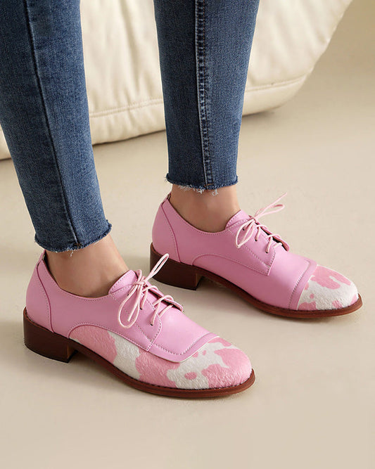 Round toe low-cut suede-trimmed cow-print loafers