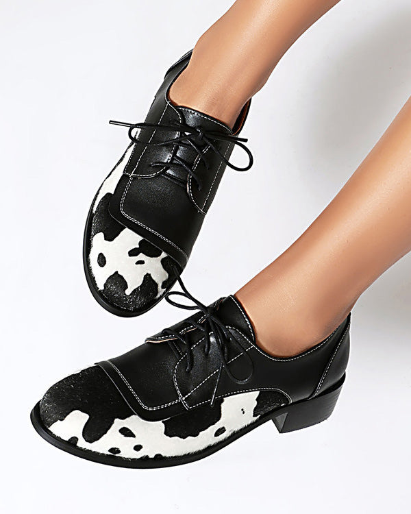 Round toe low-cut suede-trimmed cow-print loafers